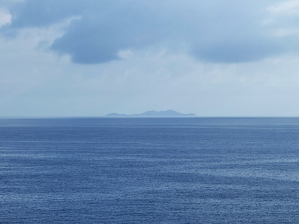 view of linosa island from lampedusa across the sea
