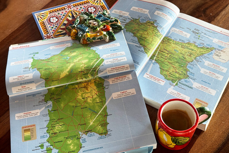 maps of sardinia and sicily with espresso cup and magnet on top