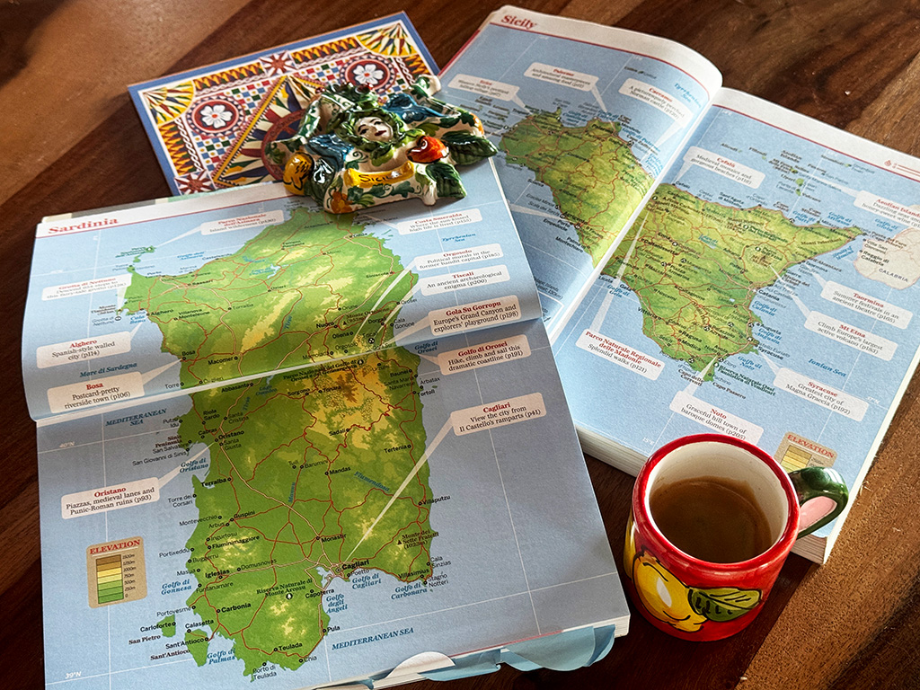 maps of sardinia and sicily with espresso cup and magnet on top