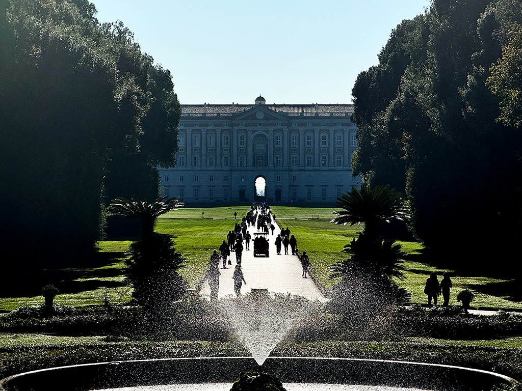 fountain and gardens with palace of caserta behind