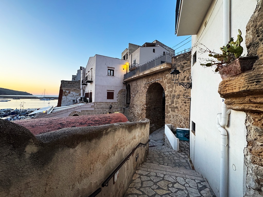 narrow stone steps and white houses on the way to the port in castellammare del golfo sicily