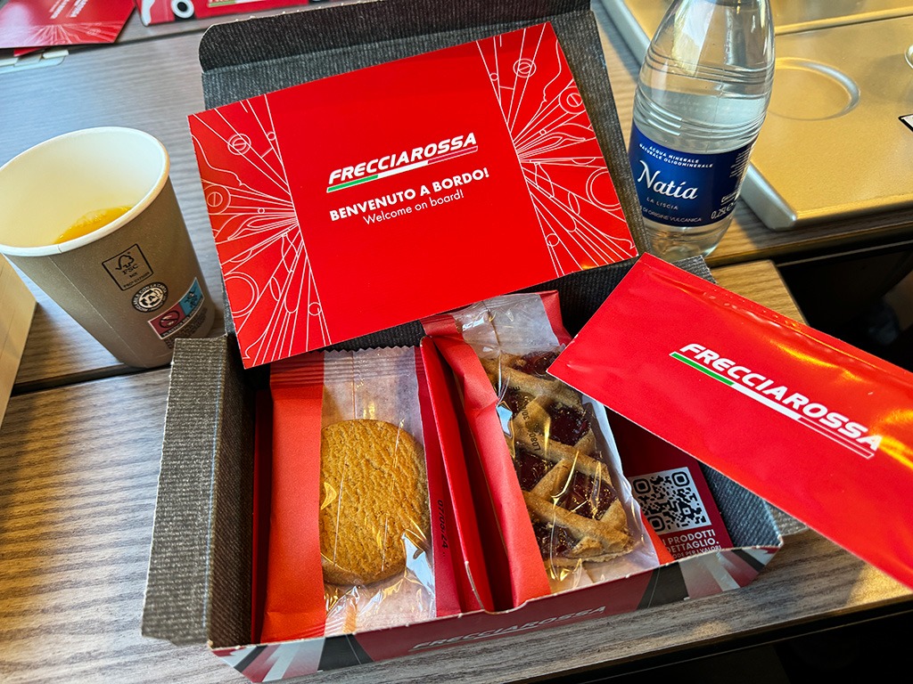 first class snack box with biscuits and cake on frecciarossa train