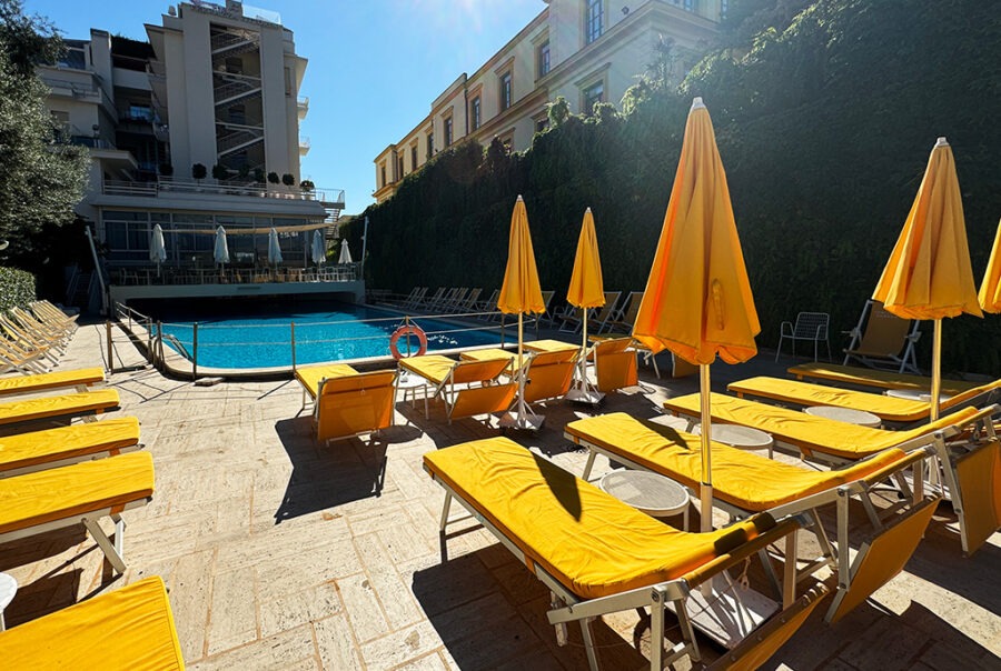 yellow sunbeds and parasols around swimming pool of hotel continental sorrento
