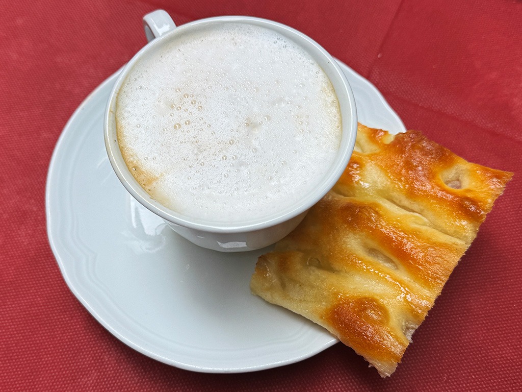 ligurian breakfast of cappuccino and piece of focaccia bread