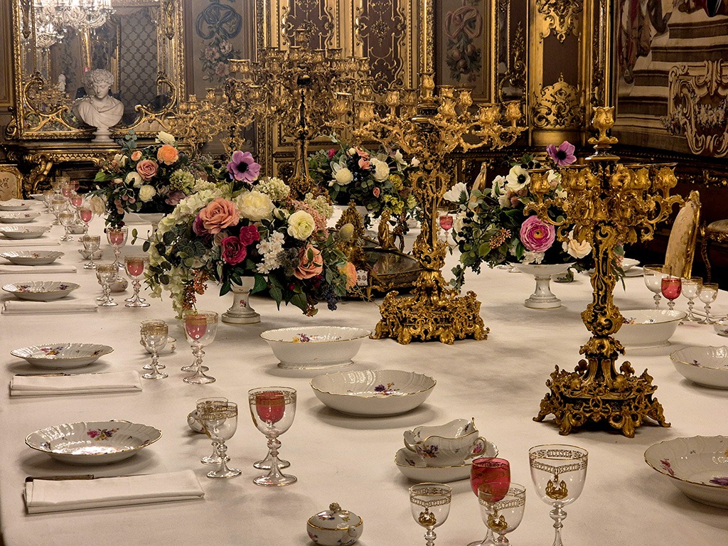 close up of royal dining table set with crockery and glasses in turin royal palace