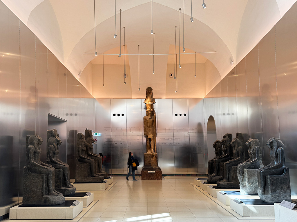 gallery in turin egyptian museum with statues either side and at the end of the room