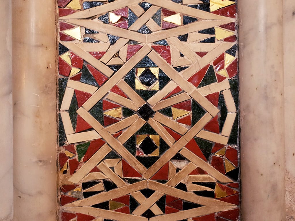 close up detail of red black and gold mosaic in monreale cathedral