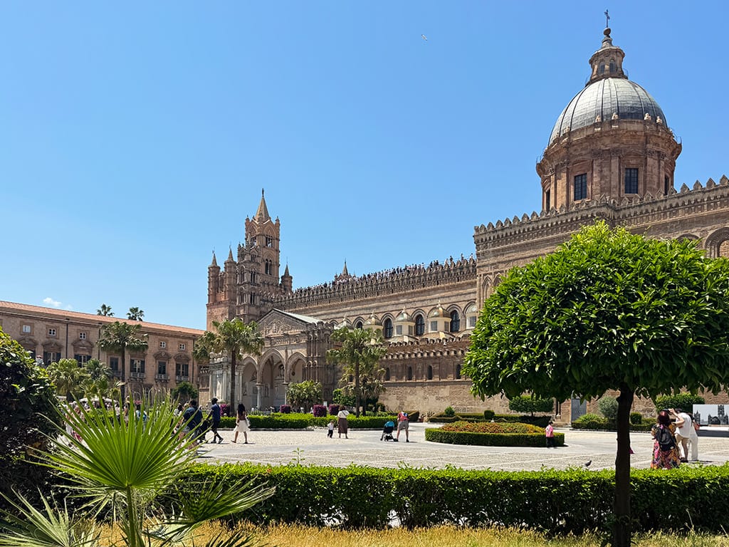 exterior of palermo cathedral with piazza and trees in front