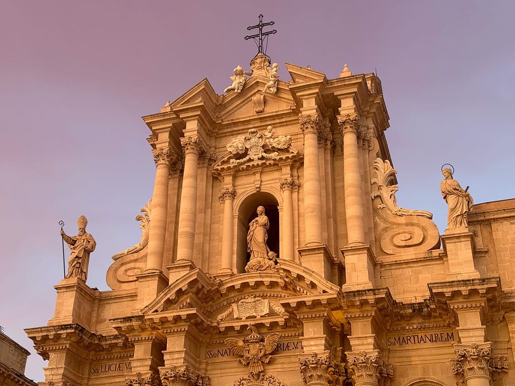 facade of duomo at sunset with pink coloring