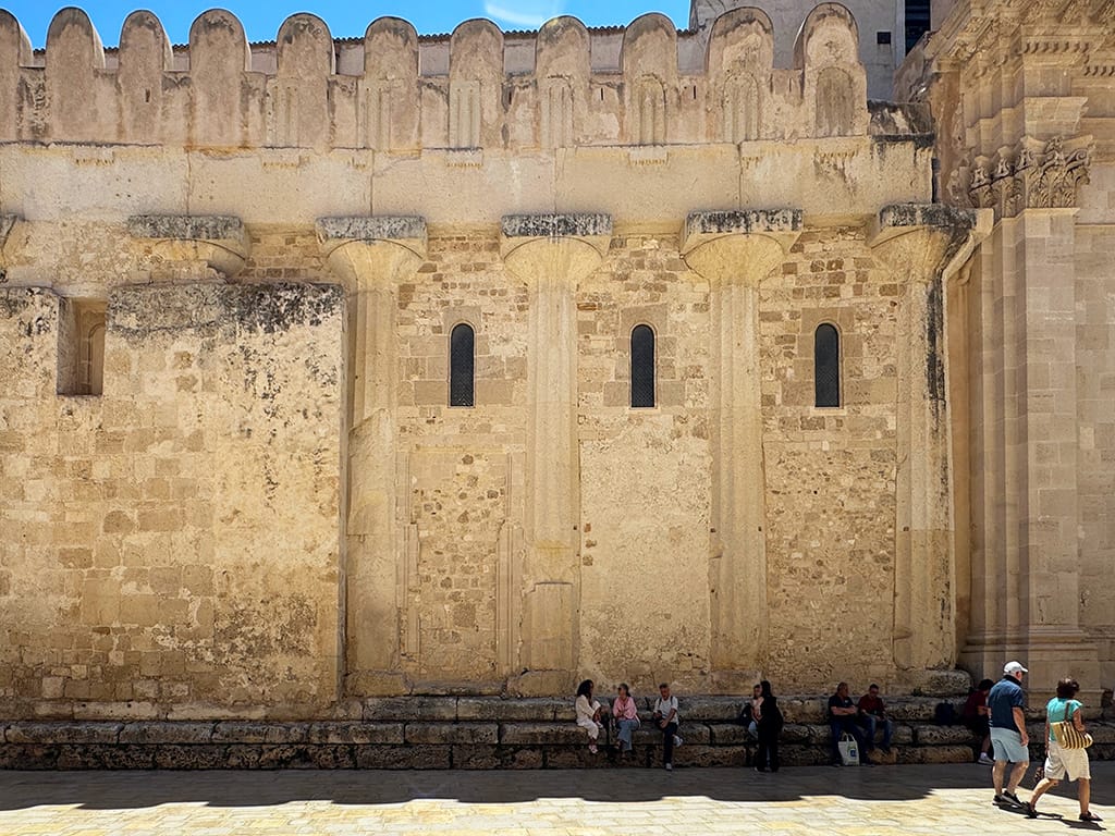 exterior side of cathedral with ancient columns visible among the brickwork