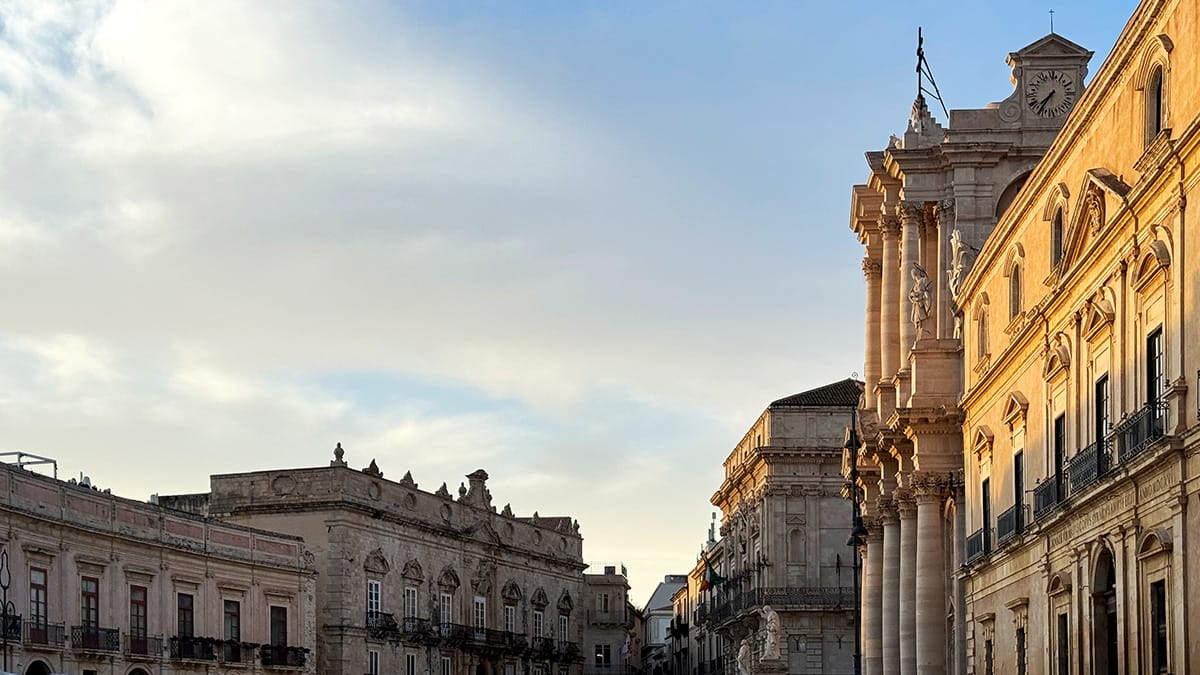 wide view of piazza duomo in ortigia at sunset